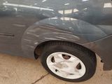 a car that has been dented and is parked in a garage