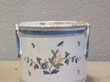 a small blue and white vase with a bird on it