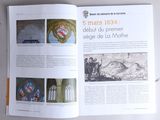 an open book with pictures of a building and a clock