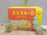 a box with a toy of a dinosaur and a toy of a cat