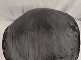 a black plastic ball sitting on top of a white sheet