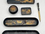 a black and gold set of items on a white table