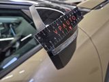 a close up of a car ' s side mirror with a ruler on it