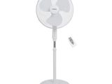 an image of a white fan with a remote control sitting on a stand