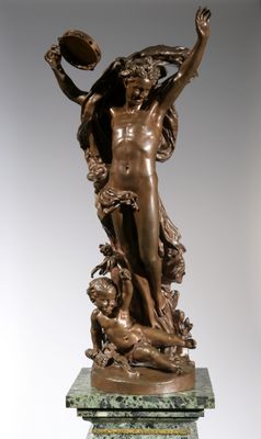 bronze statue of a woman holding a ball on a pedestal