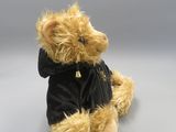 a teddy bear that is wearing a black shirt