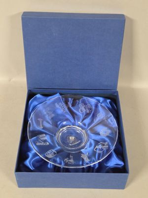 an empty glass bowl in a blue box on a white surface