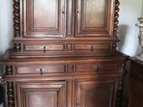 a large wooden cabinet with a bowl on top of it