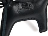 black leather horse shaped keychain with a bow on the back