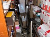 a room with a lot of boxes on the floor and a floor lamp
