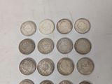several different types of coins are arranged on a white surface