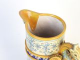 a vase with a bird on top of it on a table
