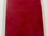 a red book sitting on top of a white table