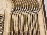 many spoons and forks in a case on the table