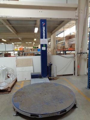 an image of a warehouse with a large metal object in the middle of the floor