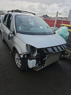 une camionnette blanche endommagée, garée sur le parking