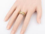 a close up of a person ' s hand with a ring on it