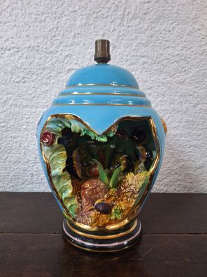 un vase bleu contenant un poisson, posé sur une table
