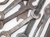 a lot of wrenches that are laying on a table