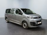 the silver van is parked in the empty room of the building