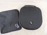 a black bag and a black case on a white surface