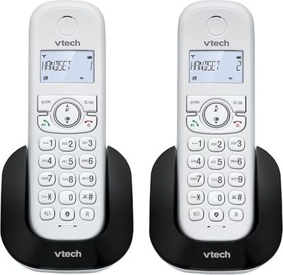 the two phones are sitting side by side next to each other