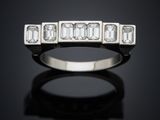 a white gold ring with baguets and diamonds