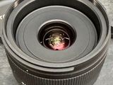 a camera lens sitting on a table next to a box