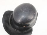 a black hat sitting on top of a white table