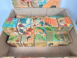 boxes of children ' s books are stacked on top of each other in a cardboard box