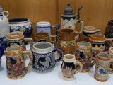 many different types of beer mugs sitting on a table