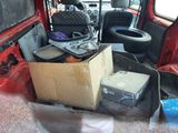 a red van with a bunch of luggage in the back of it