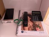 a phone and a calculator sitting on a desk