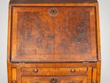 an old wooden desk with three drawers and a drawer on top of it