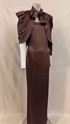 an image of a mannequin with a brown dress on a mannequin stand