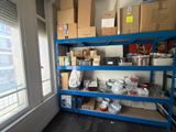 a blue shelving with boxes on it in a room