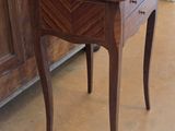 a small wooden table with a drawer on top of it