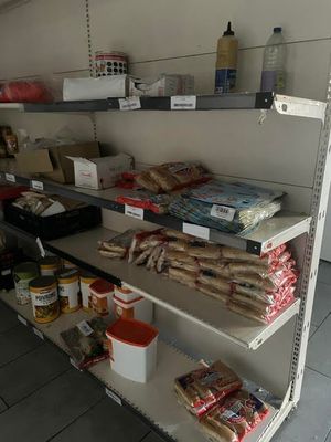 a shelf of food and other items in a store