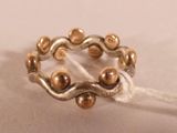 an image of a ring made of silver and gold beads