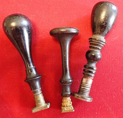 pair of antique brass candlesticks on a red background