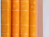 four orange books stacked on top of each other on a white surface
