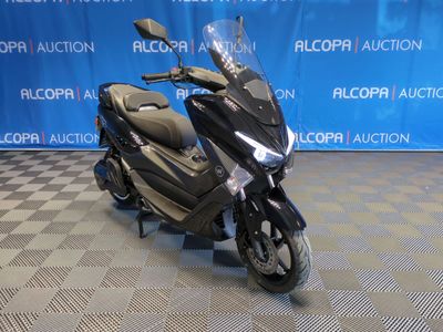 a picture of a motorcycle parked in front of a blue backdrop