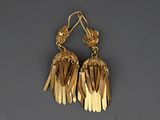 a pair of gold earrings with fringes hanging from them
