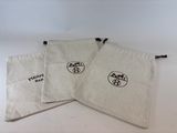 three small bags with a logo on them sitting on a table
