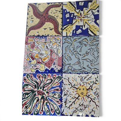 several different colored tiles with designs on them on a white surface