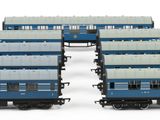 four blue and white train cars sitting next to each other on a white surface