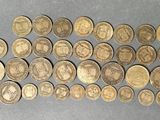 a bunch of coins sitting on top of a table next to each other