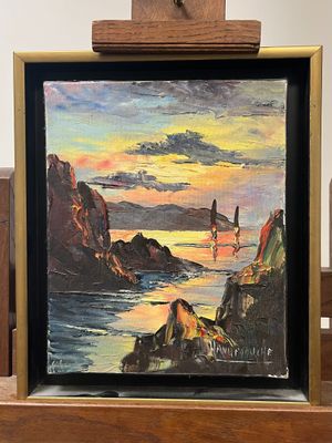 a picture of a painting hanging on a wooden easel