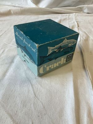 a blue box on a white sheet on a bed