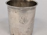 an antique silver cup with a monogram on the side
